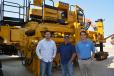 Logan Hawethorne (L) and Ken Larkin (C) of Fort Worth’s AUI Partners; and Gabe Huckabey, ROMCO project manager are pictured with a GOMACO paver ready for delivery at the Carrollton facility.
