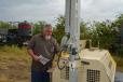 Shane Covey of Barry Burgess Equipment of Kemp, Okla., inspects a Doosan light tower that would later go up for sale.
