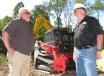 Dennis Parker (L), Takeuchi, and Tom Hover,  Fecon, discuss the powerful combination display machine —  the new Takeuchi TL12R2 compact track loader, with a stout 112 horsepower engine, equipped with a Fecon VH74 forestry mulcher.