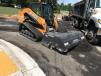 This Case TV380 compact track loader, equipped with a 72-in. Blue Diamond broom bucket, picks up the leftover material.