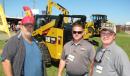 (L-R): Keith Story, Houston County, Ga., board of commissioners, and Chad Skinner and John Brazel, both of Yancey Bros. Co., talk about YANCEYAG Solutions machines, as well as other Caterpillar construction machines and attachments at the Yancey Bros. Co. display. 
 