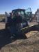 Customers from Albia, Iowa, check out a 2012 Bobcat T750 multi-terrain loader sold during the auction.
 