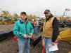 Larry Gill (L) and Rex Marshall shop the selection of attachments at the sale. 
 