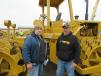 Jon Rippinger (L) of JP Rippinger and Chris Thompson of Thompson excavating Inc. inspect this Cat 815 compactor. 
 