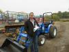 Mike Lambert of M&D Truck and Equipment Sales looks at this New Holland Workmaster 33 tractor. 
 