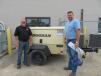 Jay Germann (L), Roland Machinery Co., goes over the features of this Doosan P185 air compressor with Kurt Cuffle, Sangamon County highway department. 
