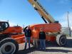 (L-R): Tyler Nowell and Justin Keigher, foremen, and Patrick Sullivan, journeyman electrician, all of Bemrich Electric, Fort Dodge Iowa, check out this JLG 1850 in the Mid Country Machinery rental fleet.
 