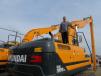 Ed Harseim, Hyundai’s district sales manager,  showcases the company’s HX300LR excavators at the event.
 