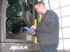 Chris Crawley, Reynolds-Warren product specialist, utilizes MecaDIAG, a Mecalac exclusive hand held diagnostic computer, to check all systems before delivering another machine.
