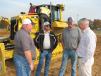 (L-R): Rusty Ledbetter, Jay Mayo and Stanley Presnell, all of Baldwin Paving, Marietta, Ga., and Jamie Thompson, Yancey Bros. Co., discuss the Trimble mastless dozer system on a Cat D6N dozer.
