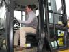 Adam Lewis of Thompson Tractor, Montgomery, Ala., takes a seat in the cab of a Cat 938 wheel loader to look over the auction catalogue.
