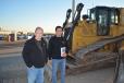 Adam Castaneda (R) of South Mountain Tractor said he is learning the equipment business from his grandfather, Mike. The Castanedas traveled from Phoenix to bid on several pieces, including this Cat D6T.
 