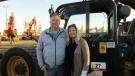 Eben (L) and Rhonda Twaddle of Interwest Construction, Burlington, Wash., enjoy the warmth of the California sun while considering this 2014 Cat 4x4x4 telescopic forklift.
 