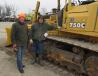 Ed Roberts (L) and Von Manifold, both of Manifold Farms, look over the dozers in the equipment yard. 
 