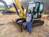 Josh Rennicker of Whipstock Natural Gas checks out a Cat mini-excavator at the auction.
 