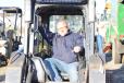 Bob Fazio, owner of Robert Fazio Landscaping in Plymouth Meeting, Pa., tries out this skid steer during the sale. 