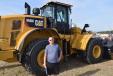 Ernie Lacroix from Ontario, Canada from Ernie Landscaping standing in front of this Cat 996 M wheel loader was glad to be in Florida and was looking forward to this auction. 
