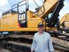 Mark Mahnen, used equipment manager of Wyoming Machinery, Casper, Wyo., checks out the extensive Caterpillar equipment on site, including this Cat 352F excavator.
