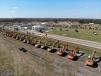 An aerial view of Yoder & Frey's 2018 Florida auction with a row of excavators.  The ramp and tent is in the background. 