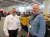 Andy Adamcik (L) of Weiler speaks with James Wittler of Casper Paving, based in Pittsburgh, Pa., about the manufacturer’s lineup of commercial pavers and road wideners.
 