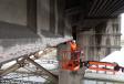 Hamilton crew injects epoxy into port openings to fill concrete cracks on the underside of the Burnside Bridge above Interstate 5. 
