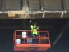 Patching cracks on the underside of the Burnside Bridge. After the cracks are filled with epoxy, they are covered with strips of carbon fiber reinforced polymer to reduce further cracking and add strength.
