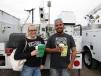 Ashley Elliott (L) and Juan Nunez of Surprise Tree Service of Surprise, Ariz., bid on their first Dodge bucket truck.

