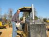 Sidney McClain of S&S Equipment Sales of Houlka, Miss., wraps up a machine inspection of a John Deere dozer. 
 