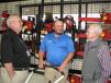 (L-R): Charles Gershowitz of Schiller Ground Care, Charlotte, N.C.; Andrew Pieplow, Florida Outdoor Equipment, Orlando, Fla.; and Bill Mason Sr. talk about all of the various manufacturer products available at this location.  
