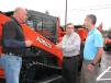 (L-R): Mason Tractor’s Mark Altwies and Kubota’s Mike Stanley speak with a regular Kubota buyer, Jeremy Myers of MMG Inc., Atlanta, Ga. 
