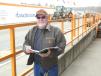 Looking over the sale catalogue is Mike Enos of Durable Undercarriage, South Plainfield, N.J.
