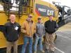 (L-R): Chuck Barnes, Ohio Cat, braves the cold to join Brandon Markey and Adam McGomery, both of Kokosing Construction Company, and Jack Weiskittel, also of Ohio Cat, to talk about this Caterpillar PM822 cold planer. 
