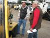 Deep in discussion about a Vermeer SC60 TX stump grinder of interest is Andy King (L) and Lee King, both of King Tree Experts, Conley, Ga. 
