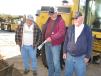 (L-R): Grading contractors Ronald Lightner of Lightner Contracting, Immokalee, Fla., and Donnie and Rodney Noland of Noland Services Inc., Carrollton, Ala., discuss the overall condition and the moldboard of a Cat 140 motor grader.  
