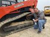 Ralph Whaley checks the sprockets on this Kubota SVL 90-2 compact track loader.  
