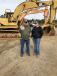 Interested in the excavators are Ronnie Ray (L) and Ryland Moore, both of Riverside Stump Dump,  Asheville, N.C.
