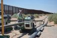 Crews begin setting up the water supply for the project. The fence seen in the background is an existing fence near the Santa Theresa Port of Entry. This fence spans approximately 1 mile and the new wall will start where this fence ends. (CEG Photo) 