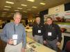 (L-R): Darren Melvin of Hanson Material Service stops by the Howell Tractor booth to speak with Alan Johnson and Phil Linoski. 