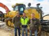 Terry Pecha (R), owner of A-1 Excavating, shows his John Deere 950K dozer to Shane Sabin (L) and Paul Stout, both of Stout Construction.