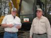 Joe Massingill (L) and Tommy Gaberlavage, both of Dudley Lumber Company, Salem, Ala., show interest in the Cat excavators. 