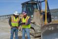Terry Suarez (R), president, T&T Earth Movers, reviews gravel paving plans for the Taylor County Expo Center with operator Paulino Hernandez. 