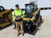 Reed Guenther (L), Hegg Contracting, has a look at this Caterpillar 239D tracked skid steer.
