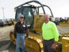 George Jackson (L) of Jackson Trucking & Excavating and Mark Sedlacek, town of Lafayette, stand in front of the Caterpillar D5K dozer.
