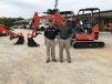 Mike Stegall (L) of Kubota and Philip Brooks showcase the Kubota U35-4 excavator. 
