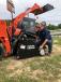 Mel Carabo of Land Pride, a division of Kubota that manufactures many of the attachments for machines such as this SVL 75-2 skid steer, looks over a machine. 