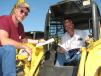 William Mussett (L) and Harley Carter, both of Carter & Son Truck & Trailer in Valliant, Okla., test operate a Deere 250 skid steer loader.  