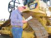George Walters of R&J Construction in Laurel, Miss., reads up on a pair of Cat D6T LGP dozers 