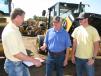 (L-R): One of the onsite vendors, Jamie Dunn of Steel Tracks Inc. in Brandon, Miss., talks with Mark and David Wallace of Wallace Lumber Co. in Summit, Miss., about his product offerings. 