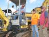 (L-R): Phillip Coleman of Fiber Tech Industries in Fairhope, Ala.; Charles Witney of Charles’ Bushwhackers Land Development in Brooklyn, Miss.; and Pete Cascio, also of Fiber Tech, test operate a Yanmar Vio27.  