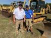 Tom Powell (L) of Joey Martin Auctioneers stands in front of a Komatsu 39PX crawler dozer with Ross McMillan of 4M Iron.
